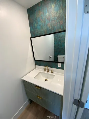 a bathroom with a sink and mirror