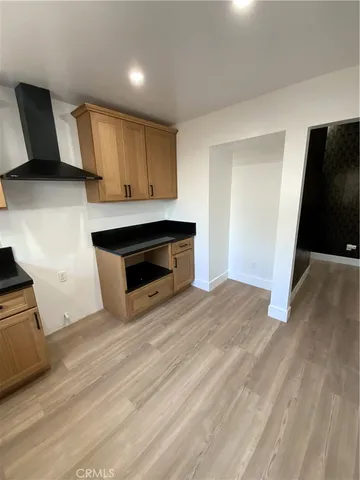 a view of kitchen with wooden floor and electronic appliances