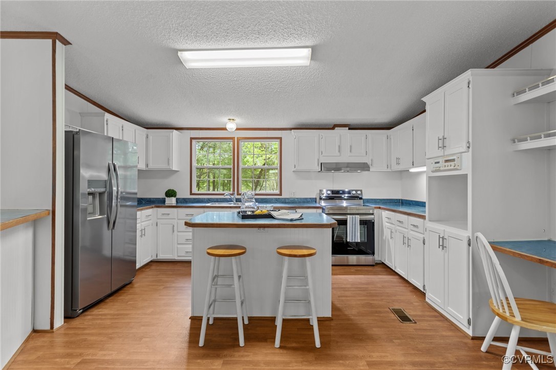 55 Redd Shop Road Farmville, VA 23901 - Photo 14 of 37 a kitchen with kitchen island granite countertop white cabinets and stainless steel appliances
