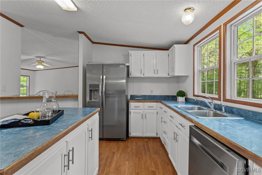 55 Redd Shop Road Farmville, VA 23901 - Photo 16 of 37 a kitchen with a sink dishwasher a refrigerator a microwave oven with wooden floor and cabinets