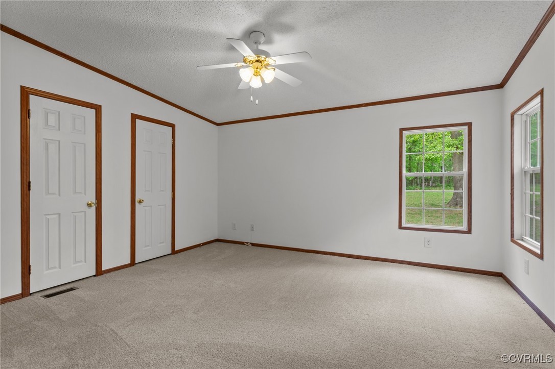 55 Redd Shop Road Farmville, VA 23901 - Photo 22 of 37 an empty room with windows and chandelier fan