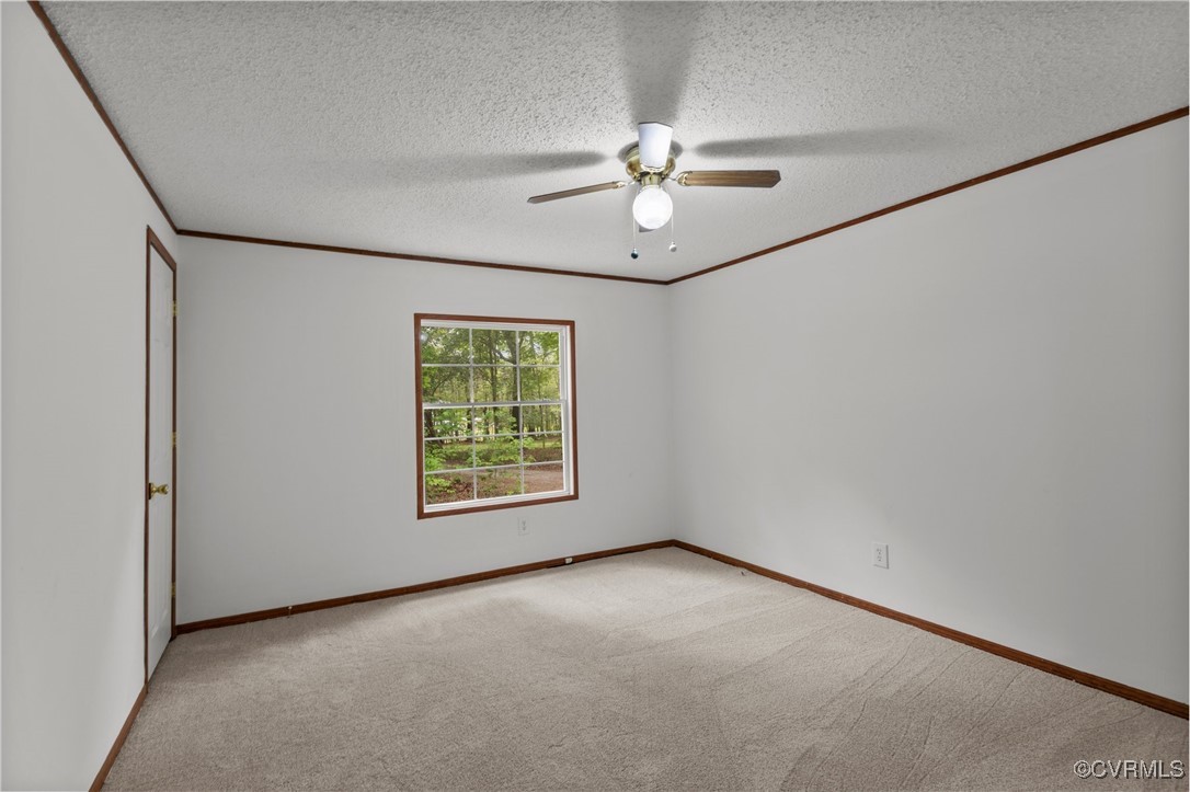 55 Redd Shop Road Farmville, VA 23901 - Photo 29 of 37 an empty room with a chandelier fan and windows