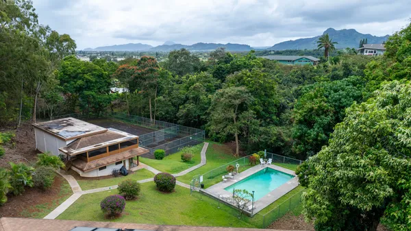 an aerial view of a house with pool patio and outdoor seating