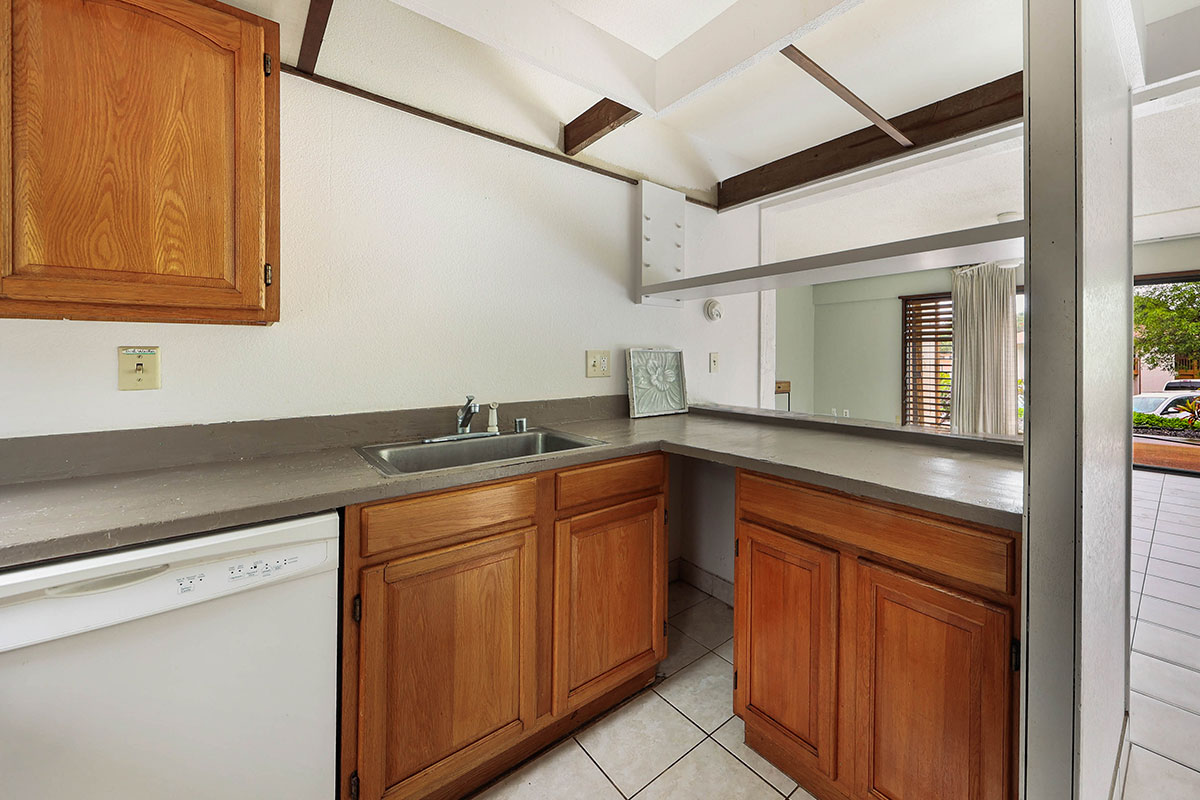 4701 Kawaihau Road, Unit A101 Kapaa, HI 96746 - Photo 18 of 25 a kitchen with granite countertop sink and cabinets