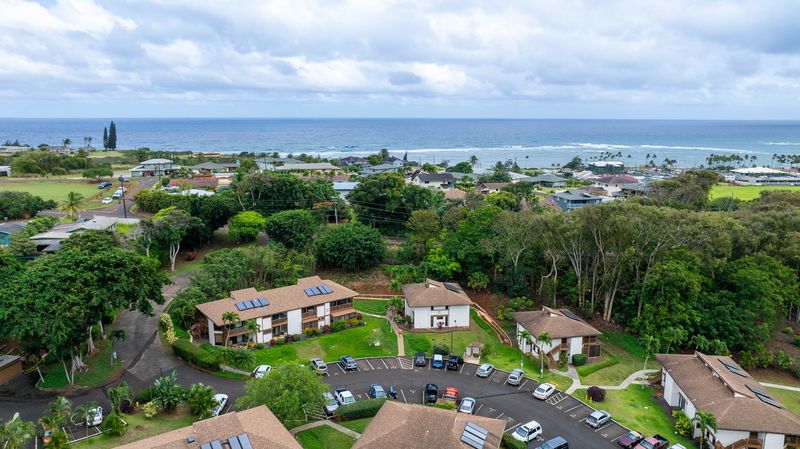 4701 Kawaihau Road, Unit A101 Kapaa, HI 96746 - Photo 22 of 25 an aerial view of a house with lots of residential buildings ocean and mountain view in back