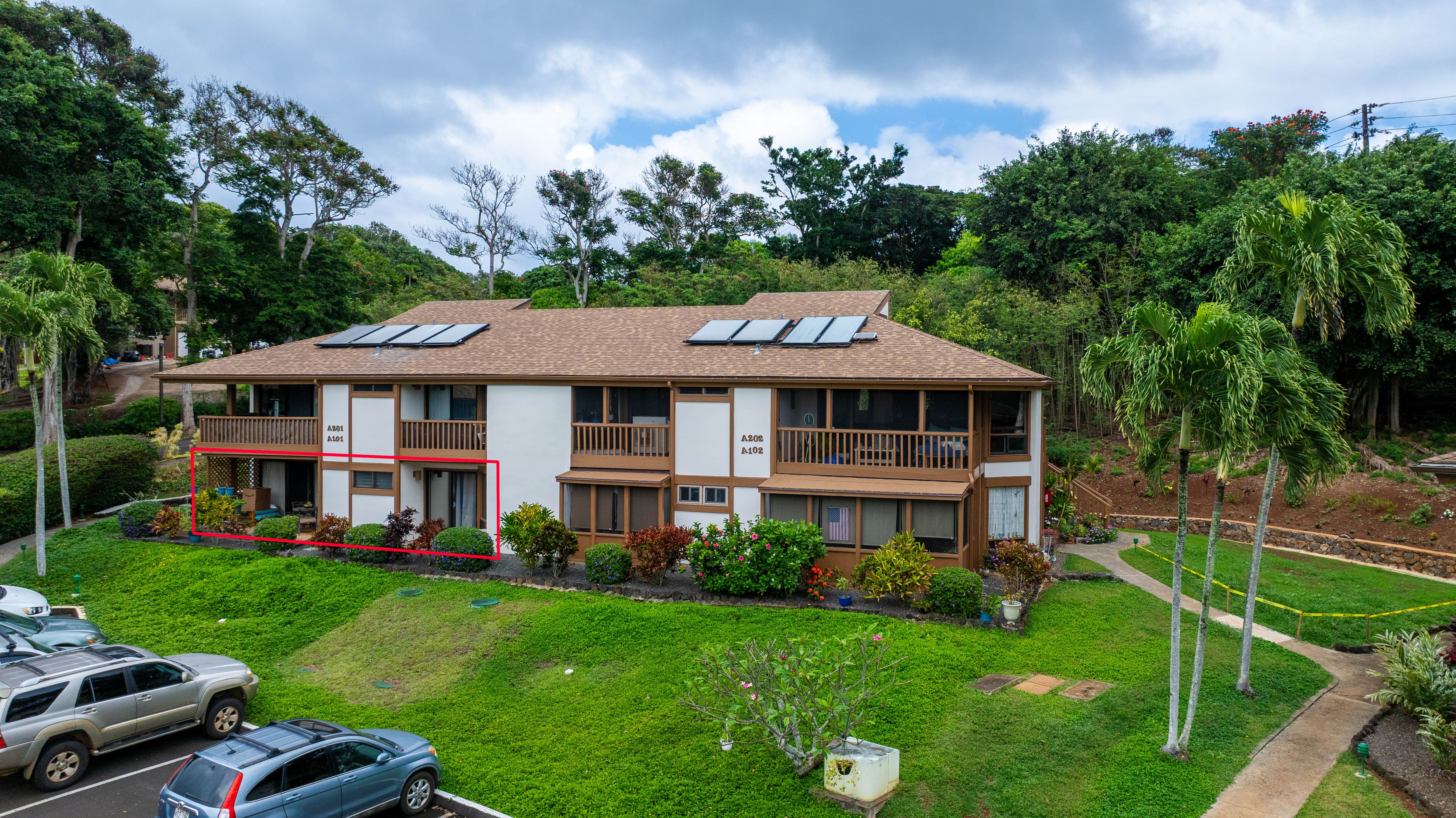 4701 Kawaihau Road, Unit A101 Kapaa, HI 96746 - Photo 23 of 25 a front view of a house with a yard table and chairs