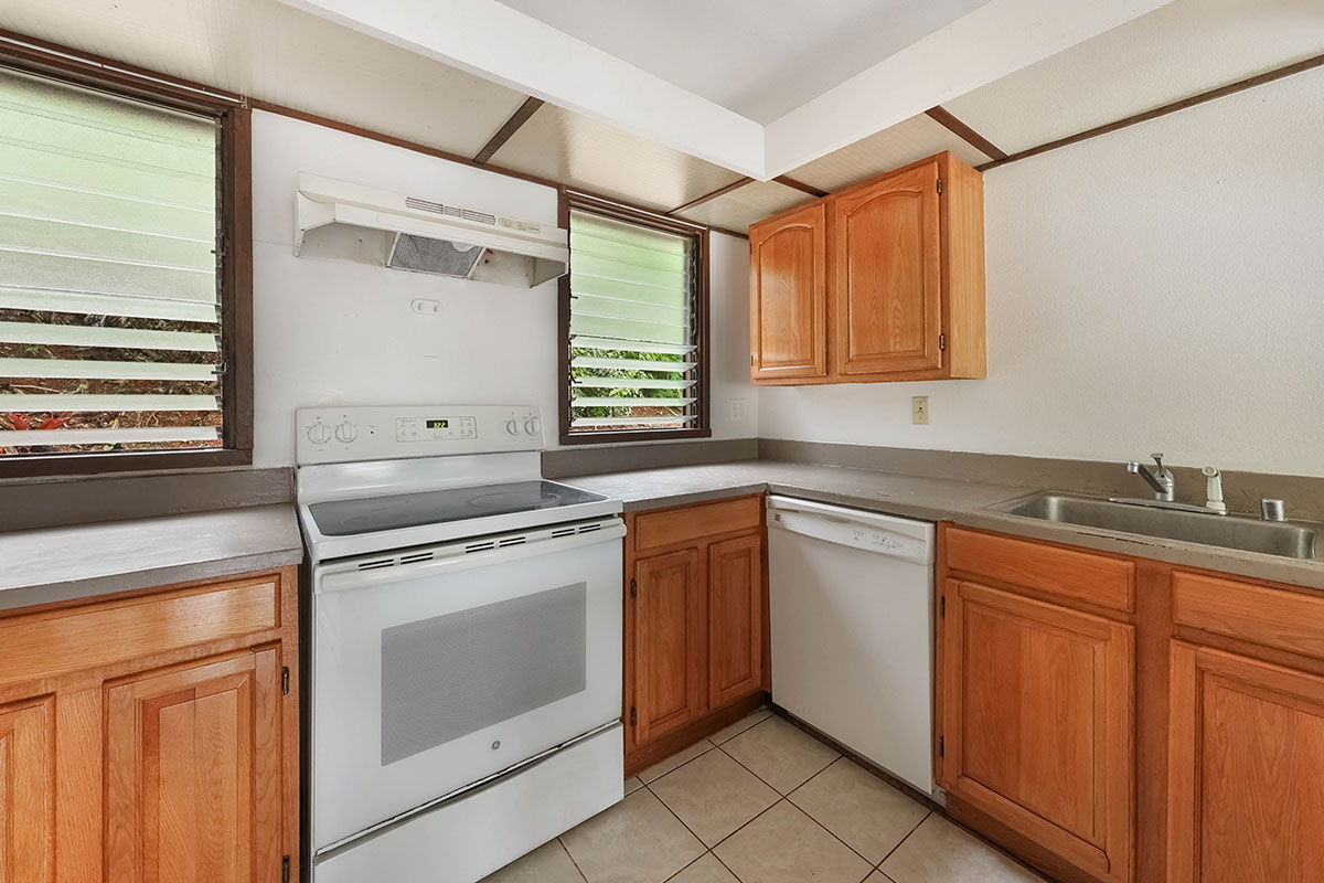4701 Kawaihau Road, Unit A101 Kapaa, HI 96746 - Photo 7 of 25 a kitchen with granite countertop a sink stainless steel appliances and cabinets