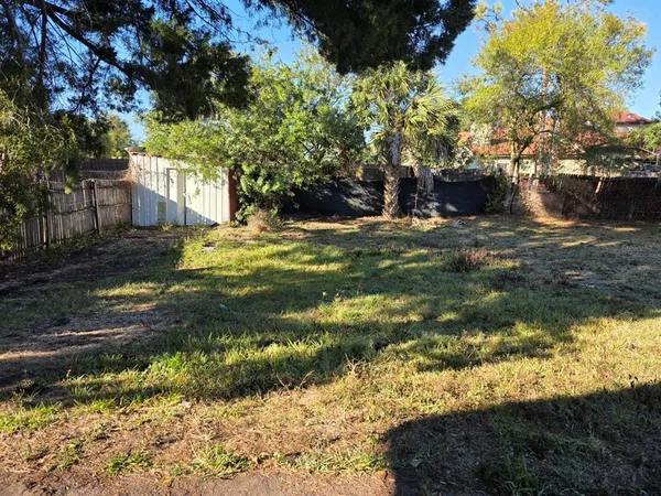 a backyard of a house with a yard and outdoor seating