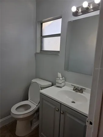 a bathroom with a sink toilet and mirror