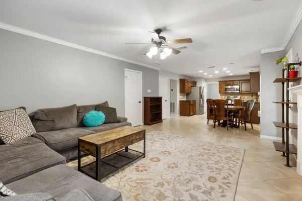 a living room with furniture and kitchen view