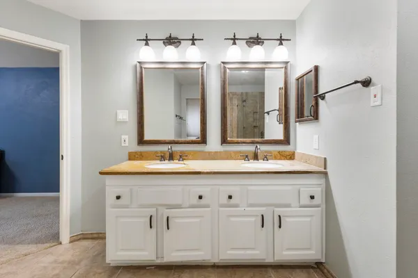 a bathroom with a sink double vanity and mirror