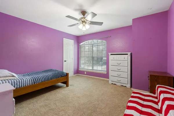 a bedroom with furniture and a chandelier