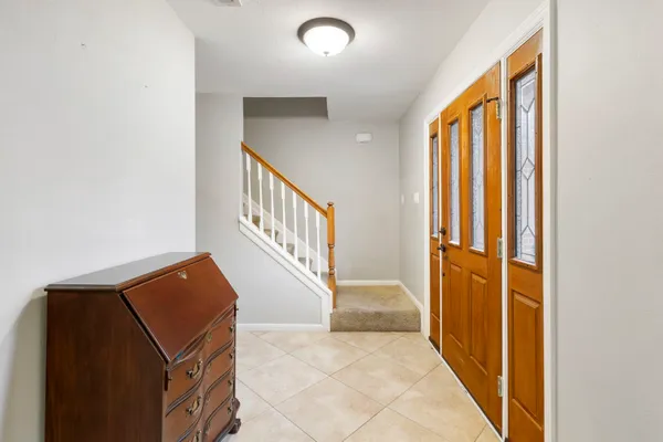 an entryway and a hall with wooden floor