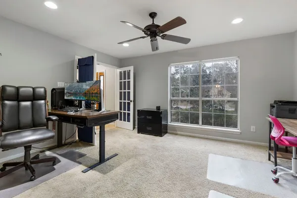 a living room with furniture and a floor to ceiling window