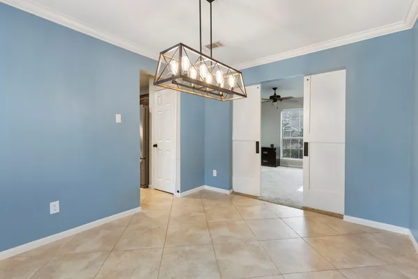 a view of a hallway with chandelier and entryway