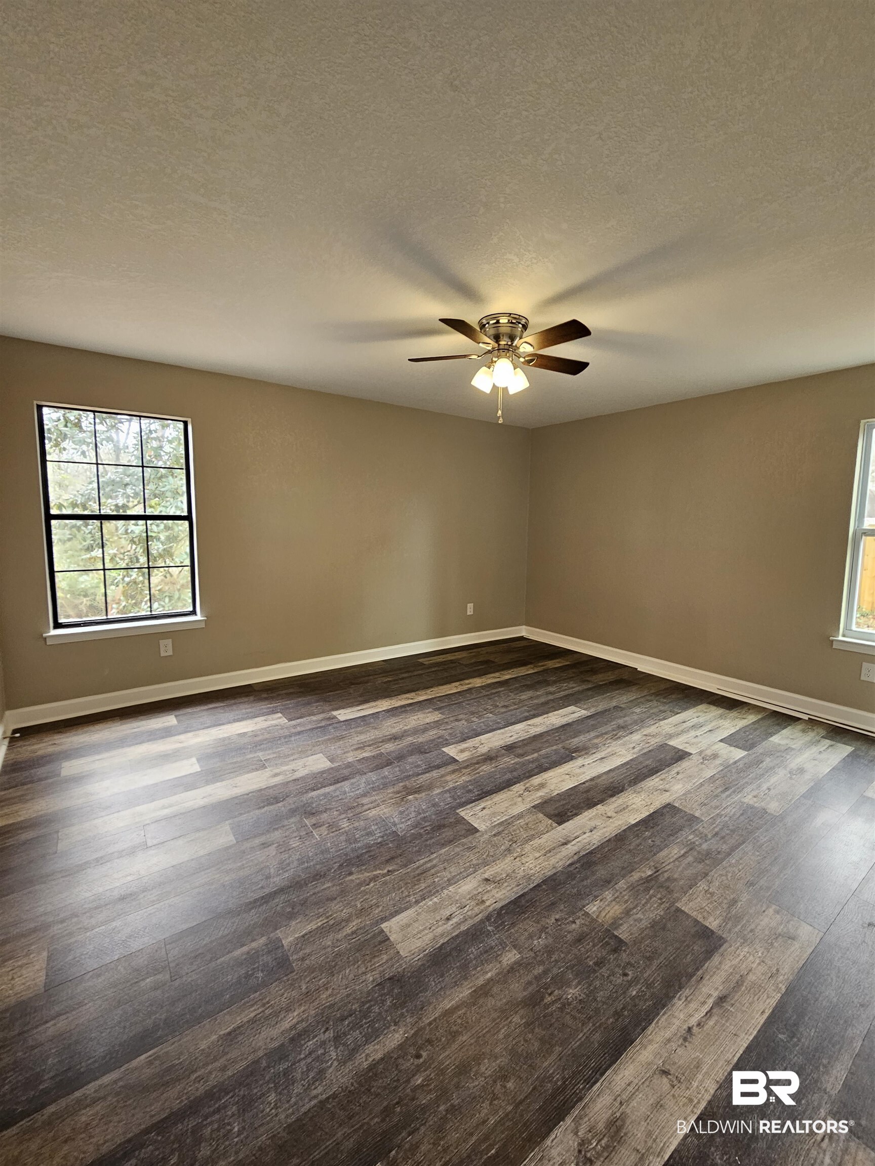 138 Wicker Way Daphne, AL 36526 - Photo 18 of 32 Spare room featuring healthy amount of natural light, a textured ceiling, ceiling fan, and dark wood finished floors