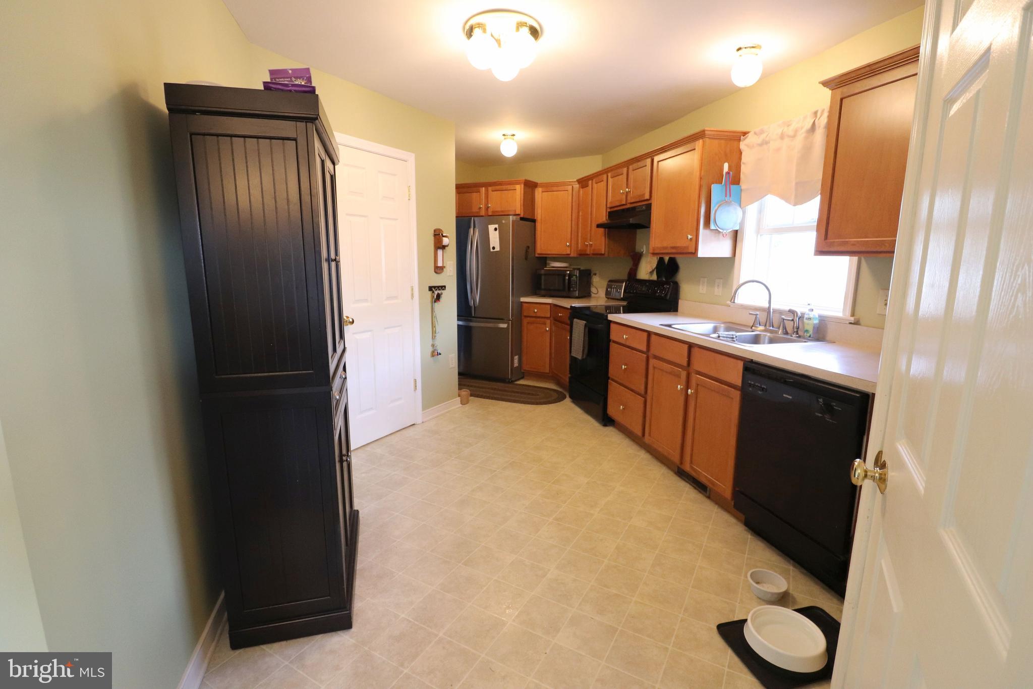 641 Chickadee Drive Lititz, PA 17543 - Photo 11 of 42 a kitchen with stainless steel appliances granite countertop a refrigerator a sink and a stove
