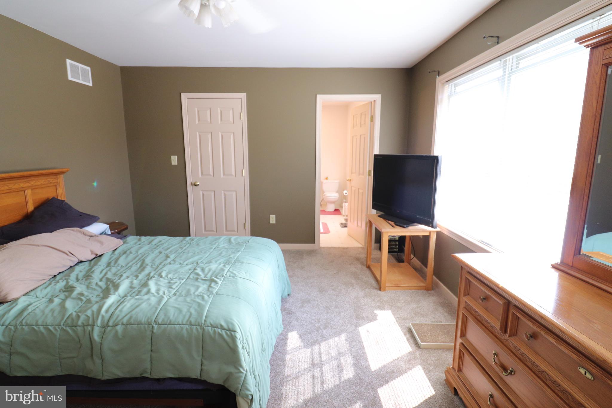 641 Chickadee Drive Lititz, PA 17543 - Photo 17 of 42 a bedroom with a bed and a flat screen tv