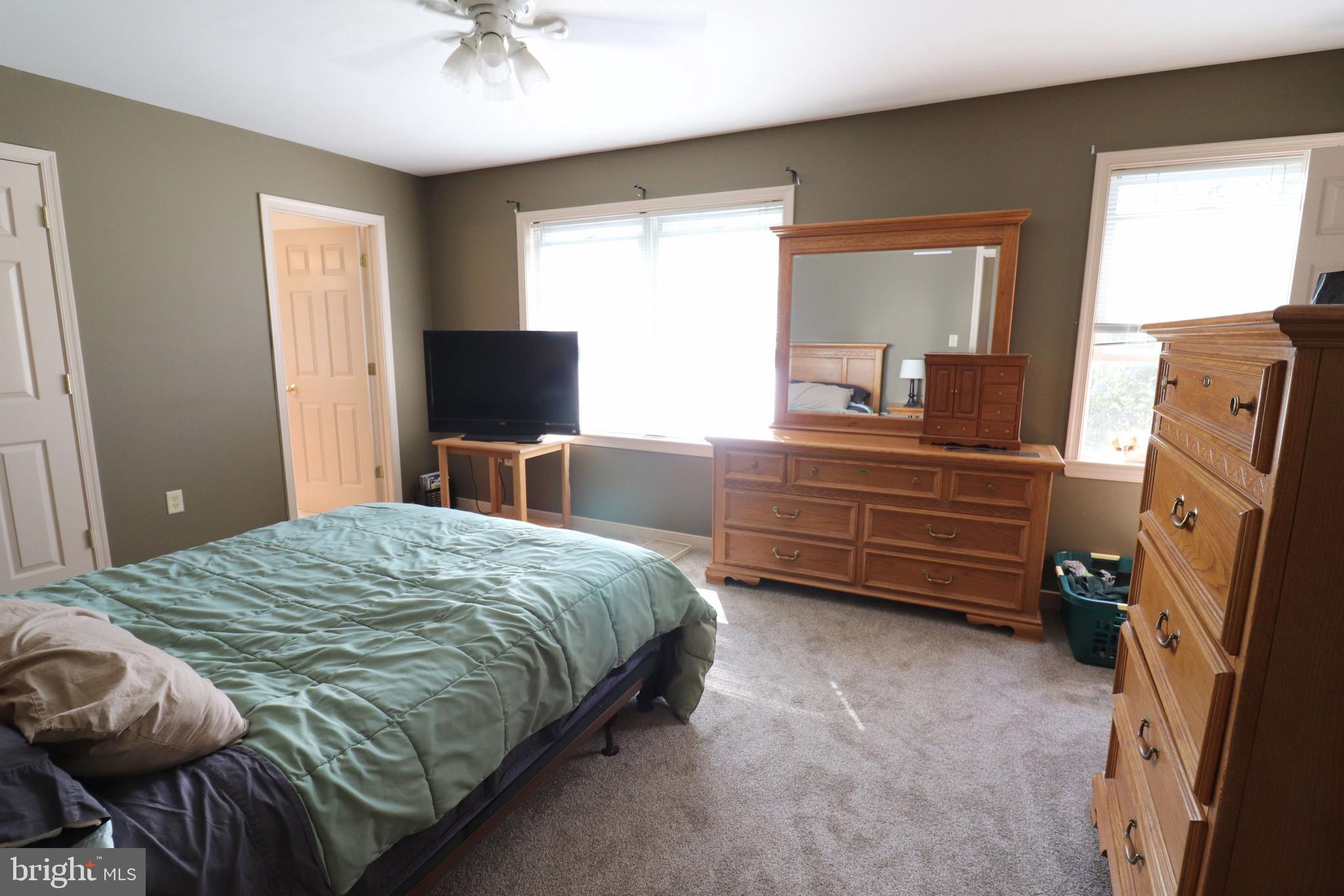 641 Chickadee Drive Lititz, PA 17543 - Photo 18 of 42 a bedroom with a bed and a flat tv screen on dresser