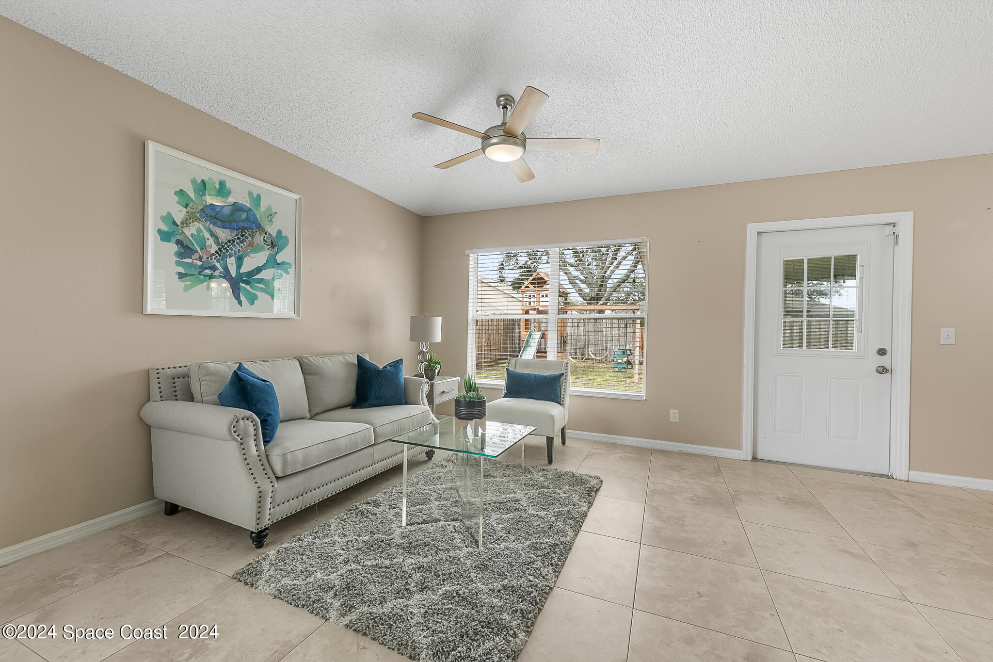 4631 Decatur Circle Melbourne, FL 32934 - Photo 15 of 35 a living room with furniture and a large window