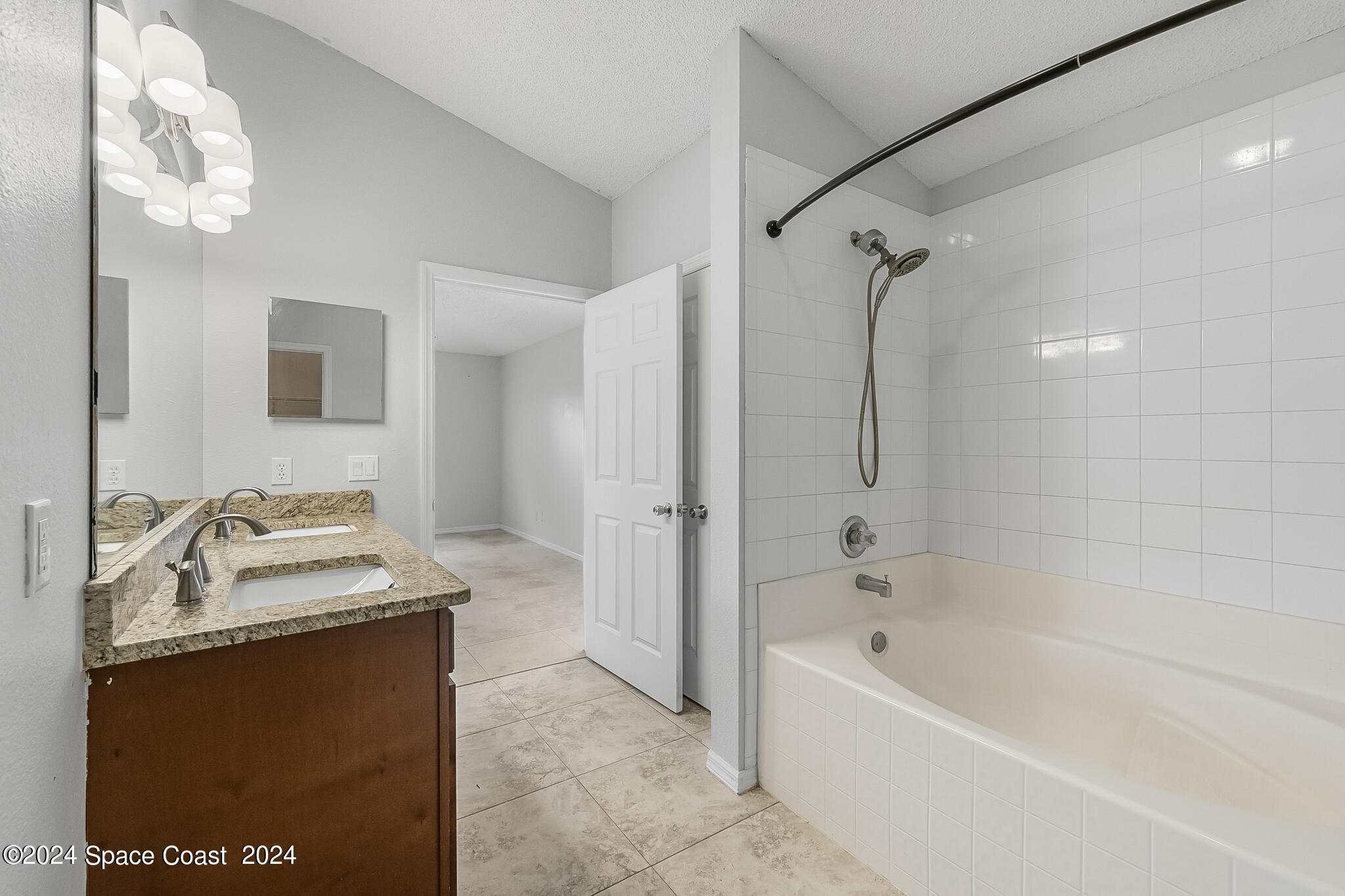 4631 Decatur Circle Melbourne, FL 32934 - Photo 24 of 35 a bathroom with a tub sink and mirror