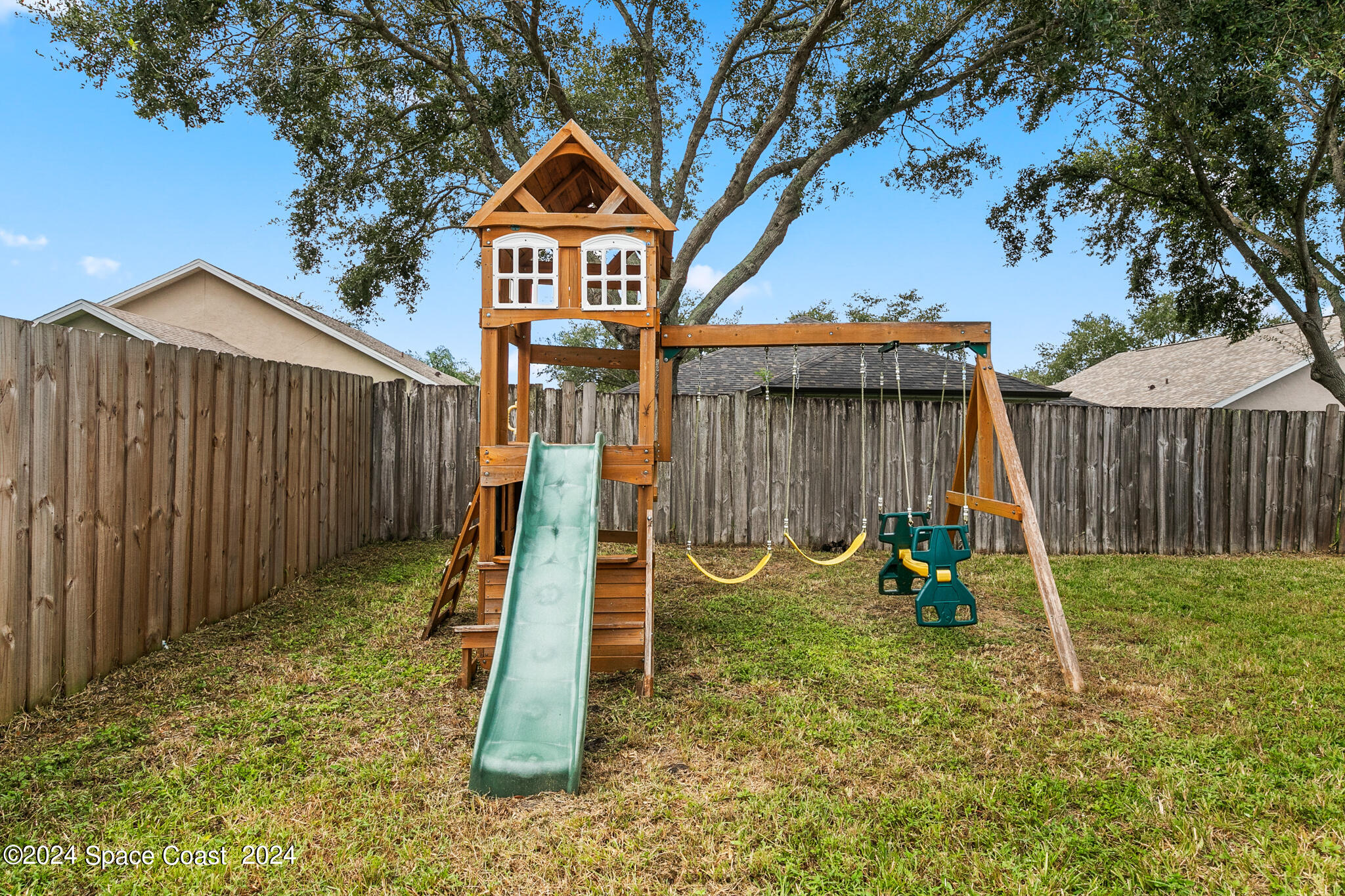 4631 Decatur Circle Melbourne, FL 32934 - Photo 31 of 35 a view of a house with a yard and a slide