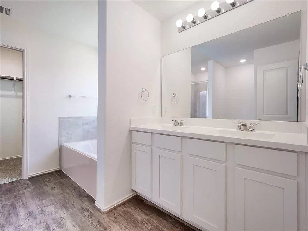 112 Concho Brook Bend Georgetown, TX 78626 - Photo 11 of 20 a bathroom with double sink and a mirror