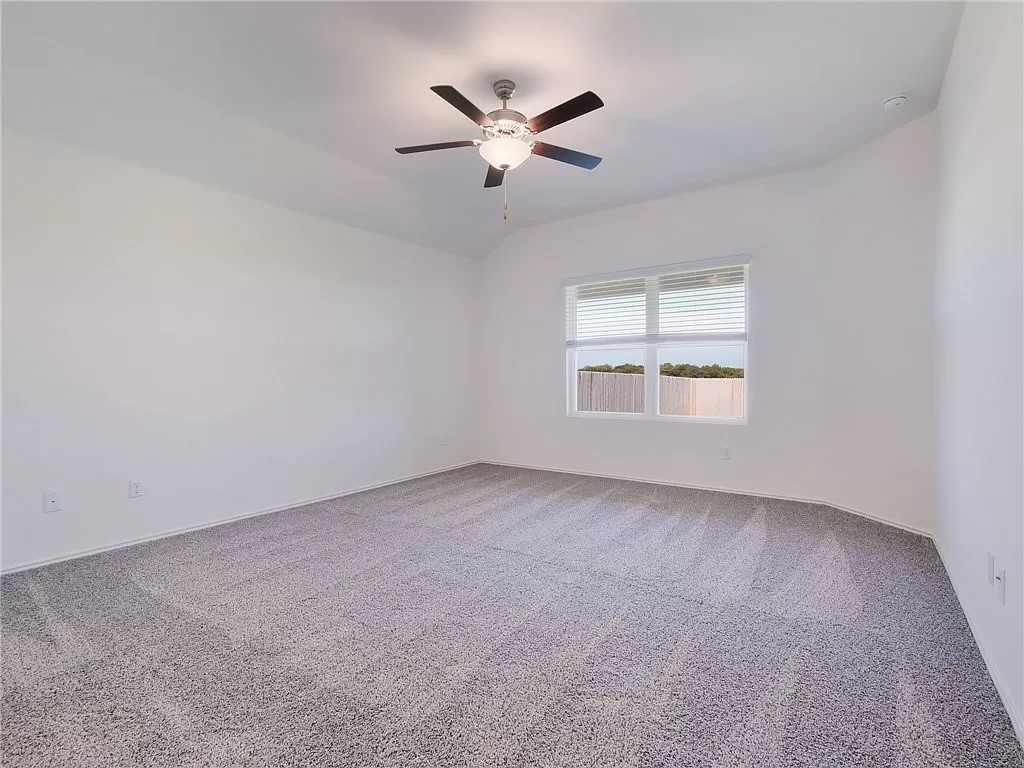 112 Concho Brook Bend Georgetown, TX 78626 - Photo 13 of 20 an empty room with ceiling fan and windows