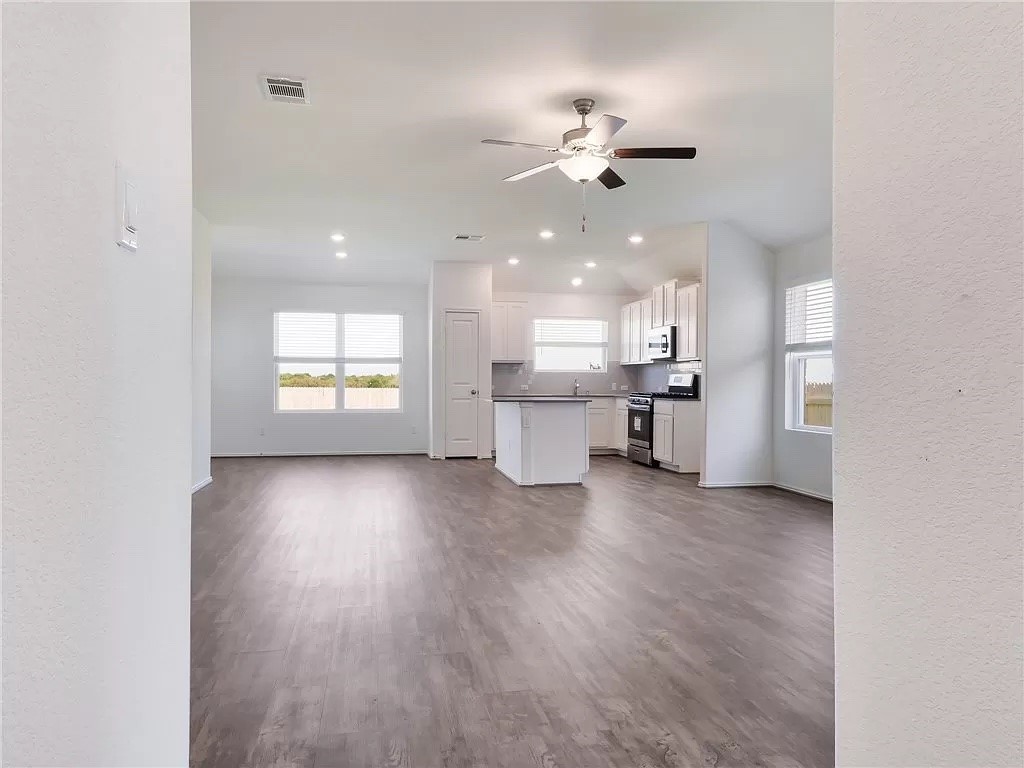112 Concho Brook Bend Georgetown, TX 78626 - Photo 3 of 20 a view of a kitchen and an empty room with a window
