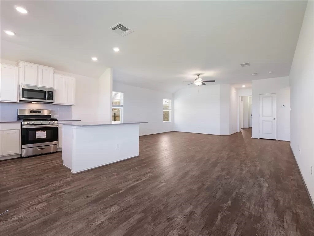 112 Concho Brook Bend Georgetown, TX 78626 - Photo 5 of 20 a view of kitchen with kitchen island stainless steel appliances cabinets and wooden floor