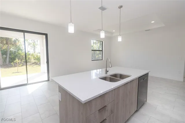 a kitchen with a sink a counter top space and a window