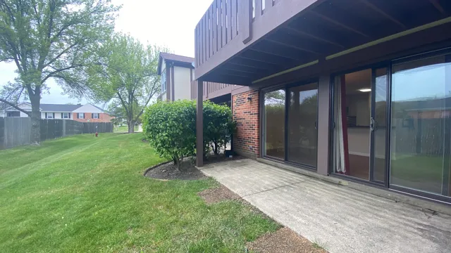 a backyard of a house with plants and outdoor seating