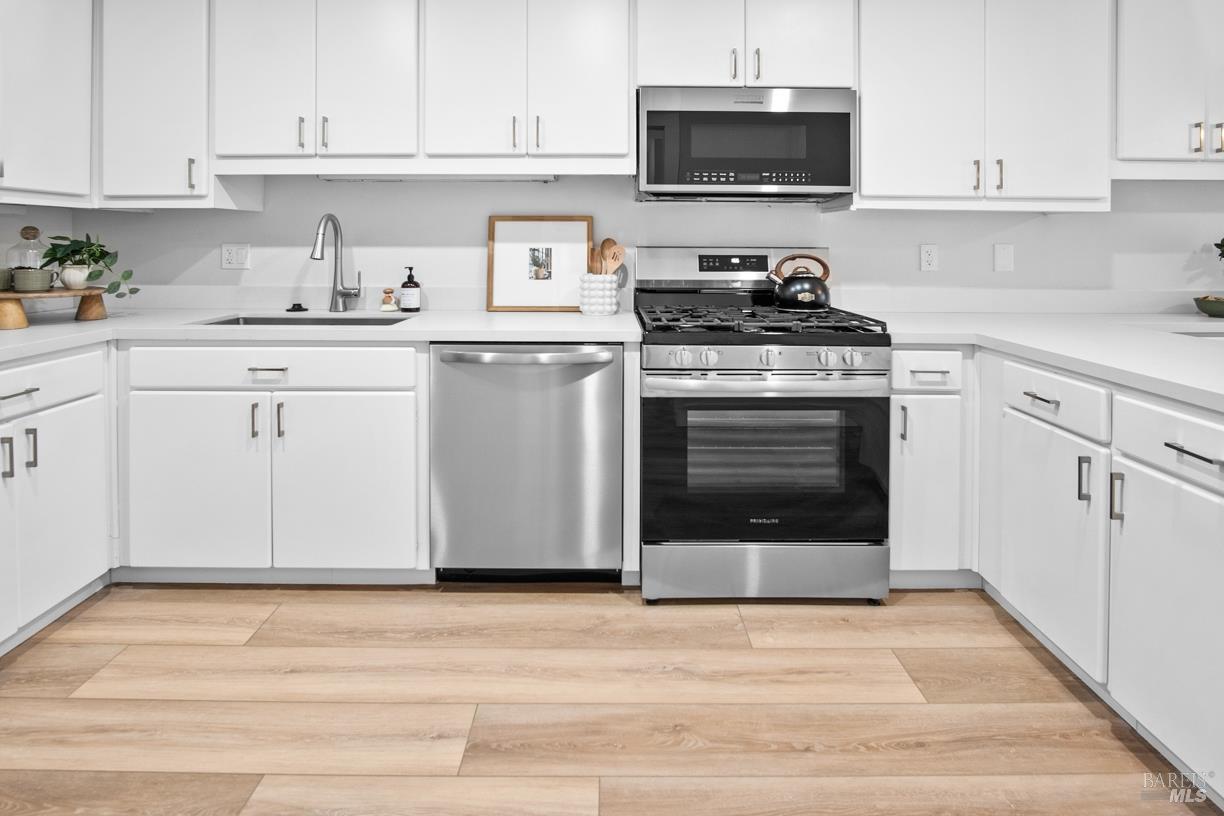 16 Drakes View Circle Greenbrae, CA 94904 - Photo 15 of 45 a kitchen with stainless steel appliances a stove a sink and a microwave