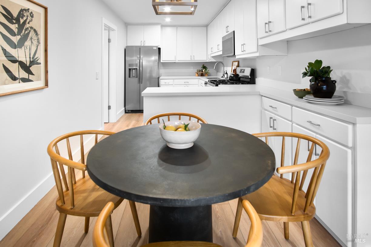 16 Drakes View Circle Greenbrae, CA 94904 - Photo 16 of 45 a kitchen with stainless steel appliances granite countertop a dining table chairs and a refrigerator