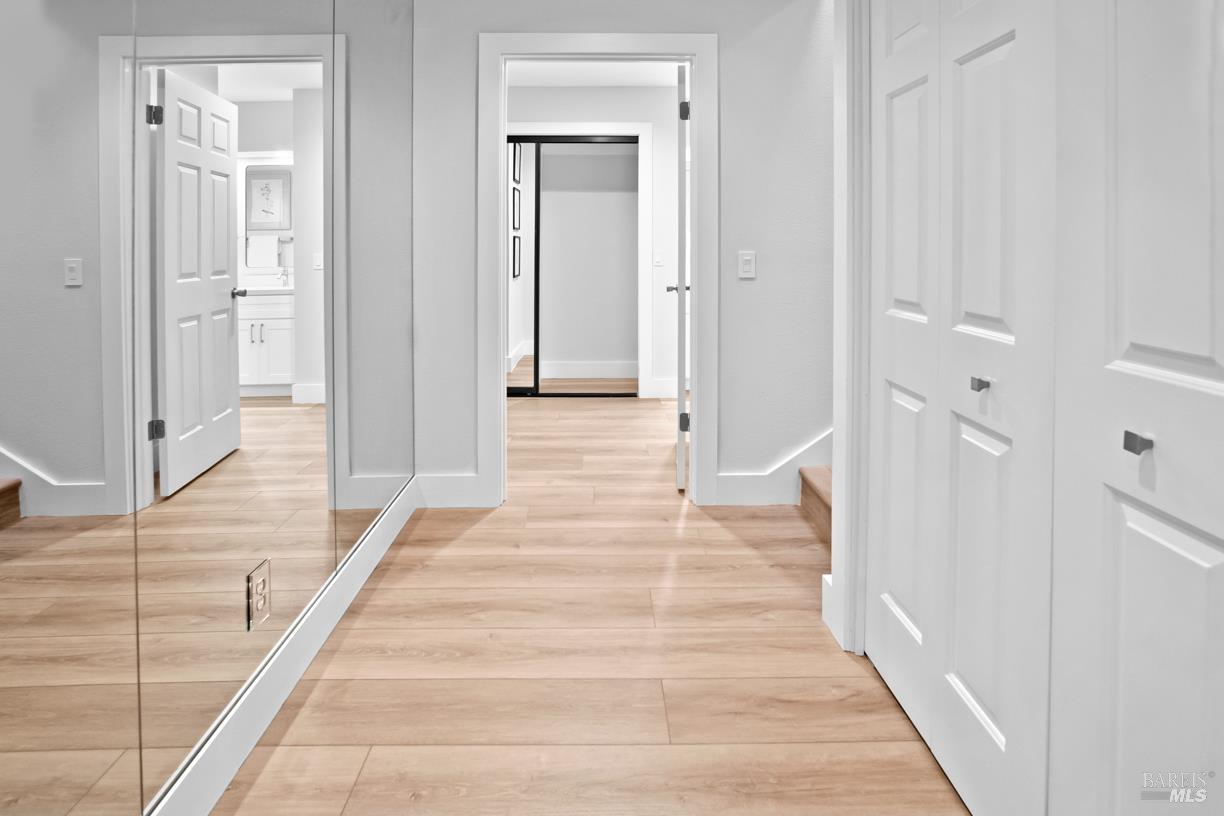 16 Drakes View Circle Greenbrae, CA 94904 - Photo 18 of 45 a view of a hallway with wooden floor and staircase
