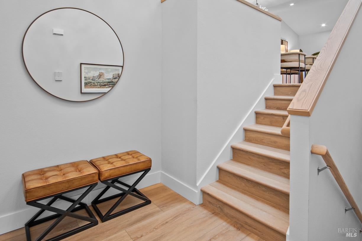 16 Drakes View Circle Greenbrae, CA 94904 - Photo 4 of 45 a view of a hallway with wooden floor and a potted plant