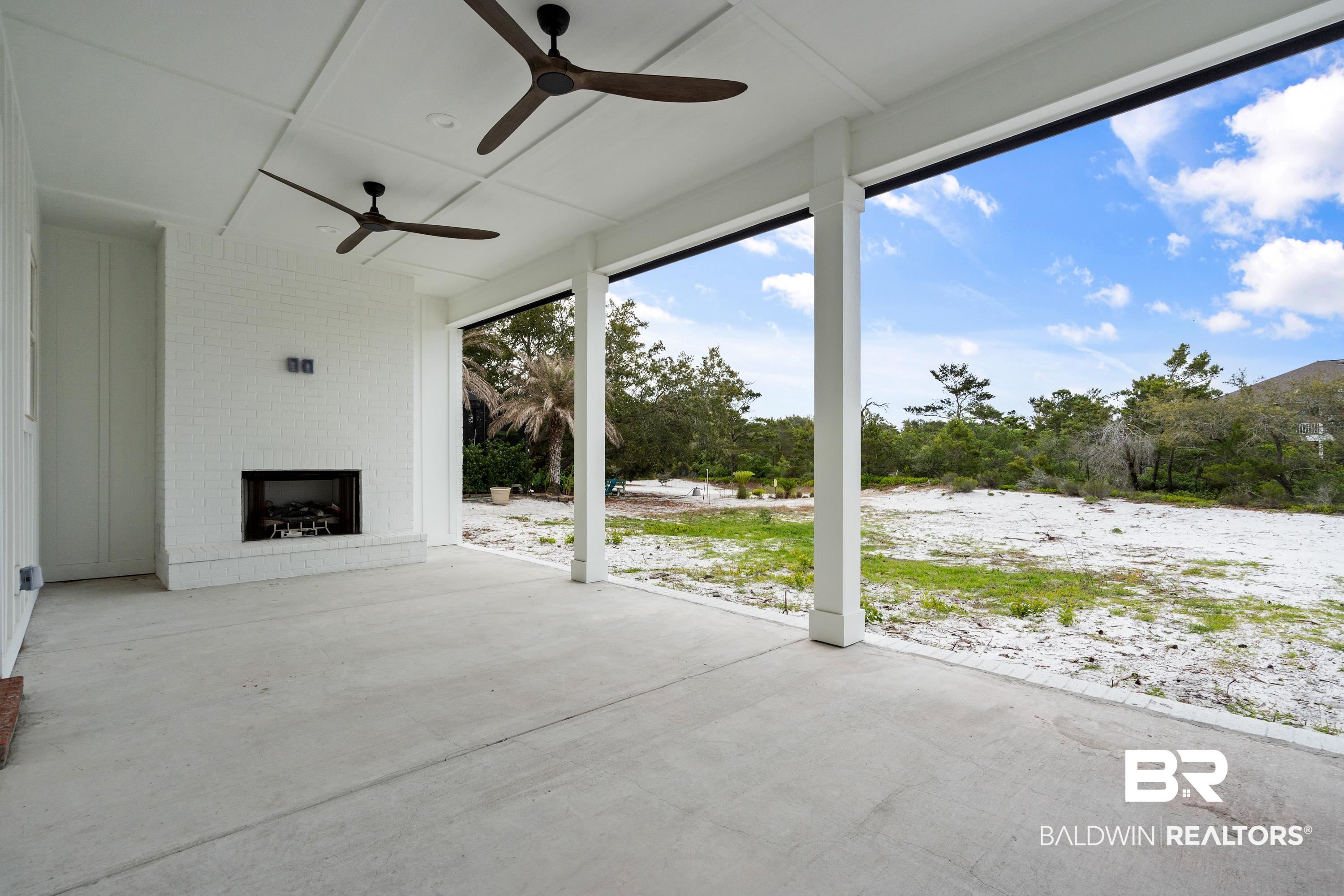 30650 Ono N Loop West Orange Beach, AL 36561 - Photo 5 of 38 View of patio / terrace featuring an outdoor brick fireplace and a ceiling fan