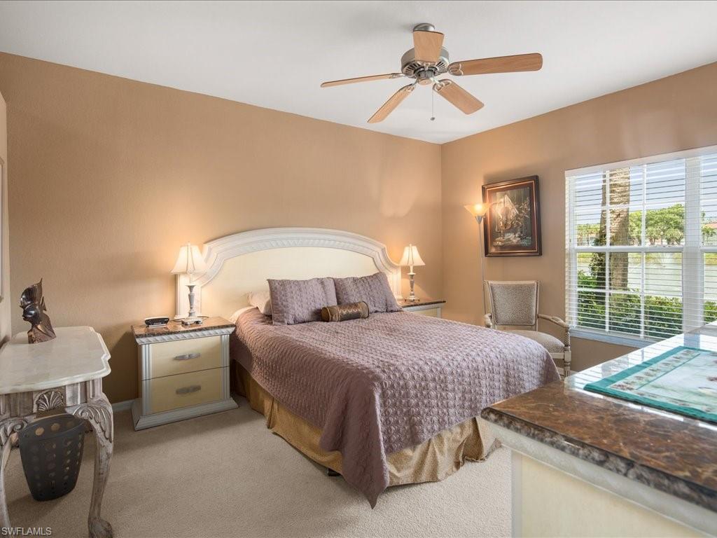10910 Oak Island Road, Unit 103 Estero, FL 34135 - Photo 11 of 24 a bedroom with a bed and a chandelier