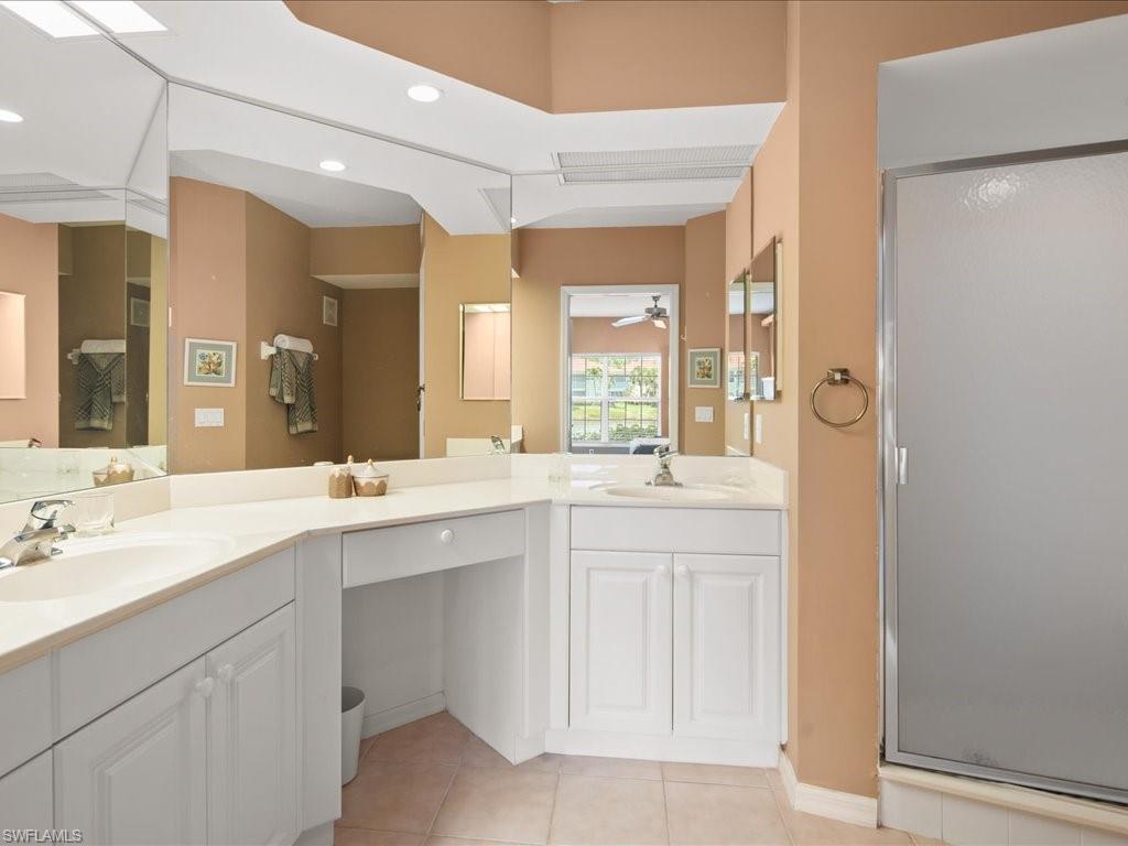10910 Oak Island Road, Unit 103 Estero, FL 34135 - Photo 12 of 24 a spacious bathroom with a double vanity sink mirror and