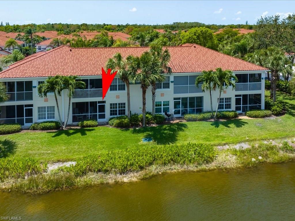 10910 Oak Island Road, Unit 103 Estero, FL 34135 - Photo 18 of 24 a view of a house with a garden and swimming pool