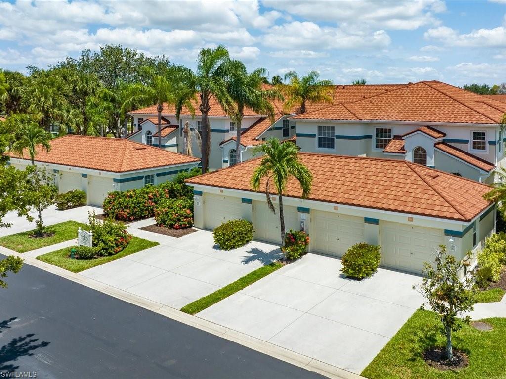 10910 Oak Island Road, Unit 103 Estero, FL 34135 - Photo 20 of 24 a view of a house with a yard and potted plants
