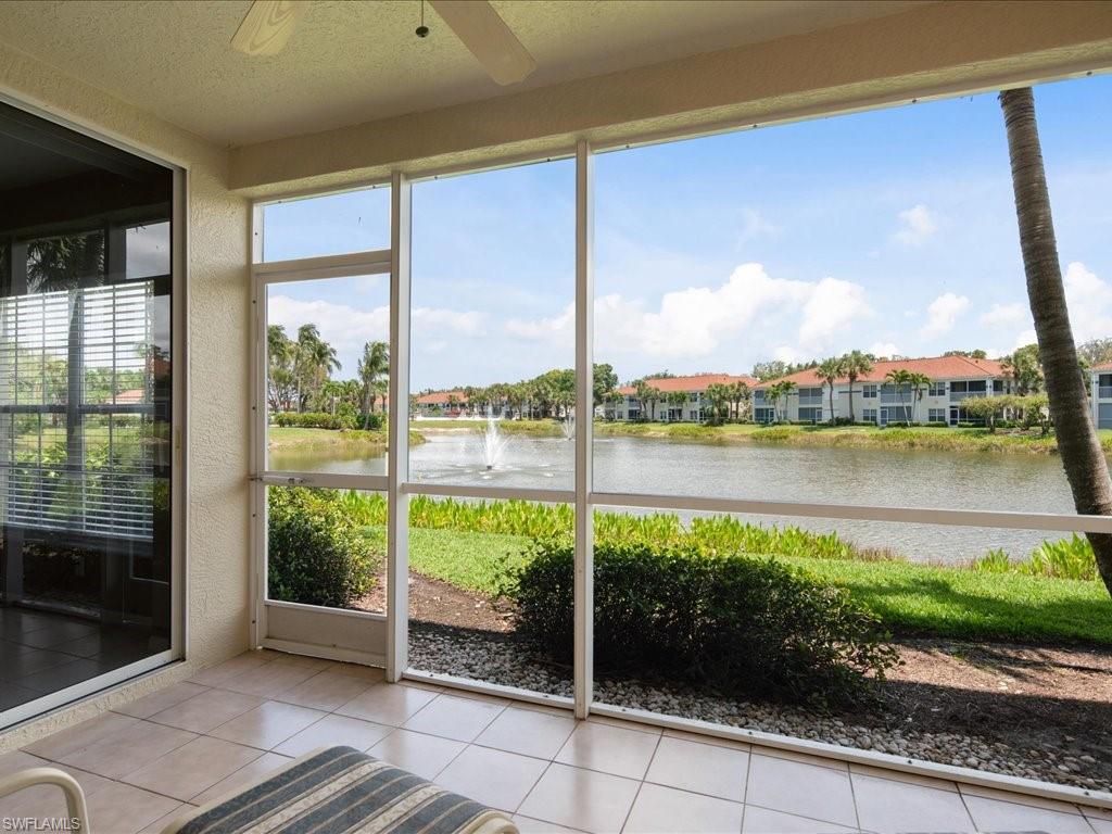 10910 Oak Island Road, Unit 103 Estero, FL 34135 - Photo 9 of 24 a view of a balcony with lake view and a floor to ceiling window