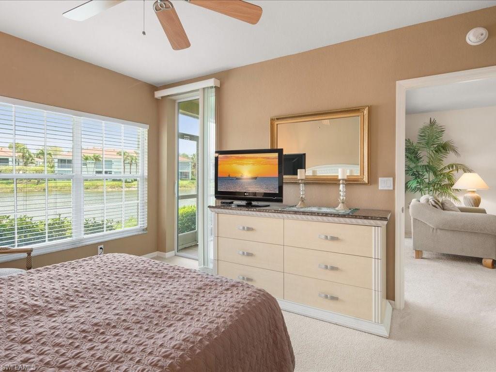 10910 Oak Island Road, Unit 103 Estero, FL 34135 - Photo 10 of 24 a bedroom with a bed and a flat screen tv