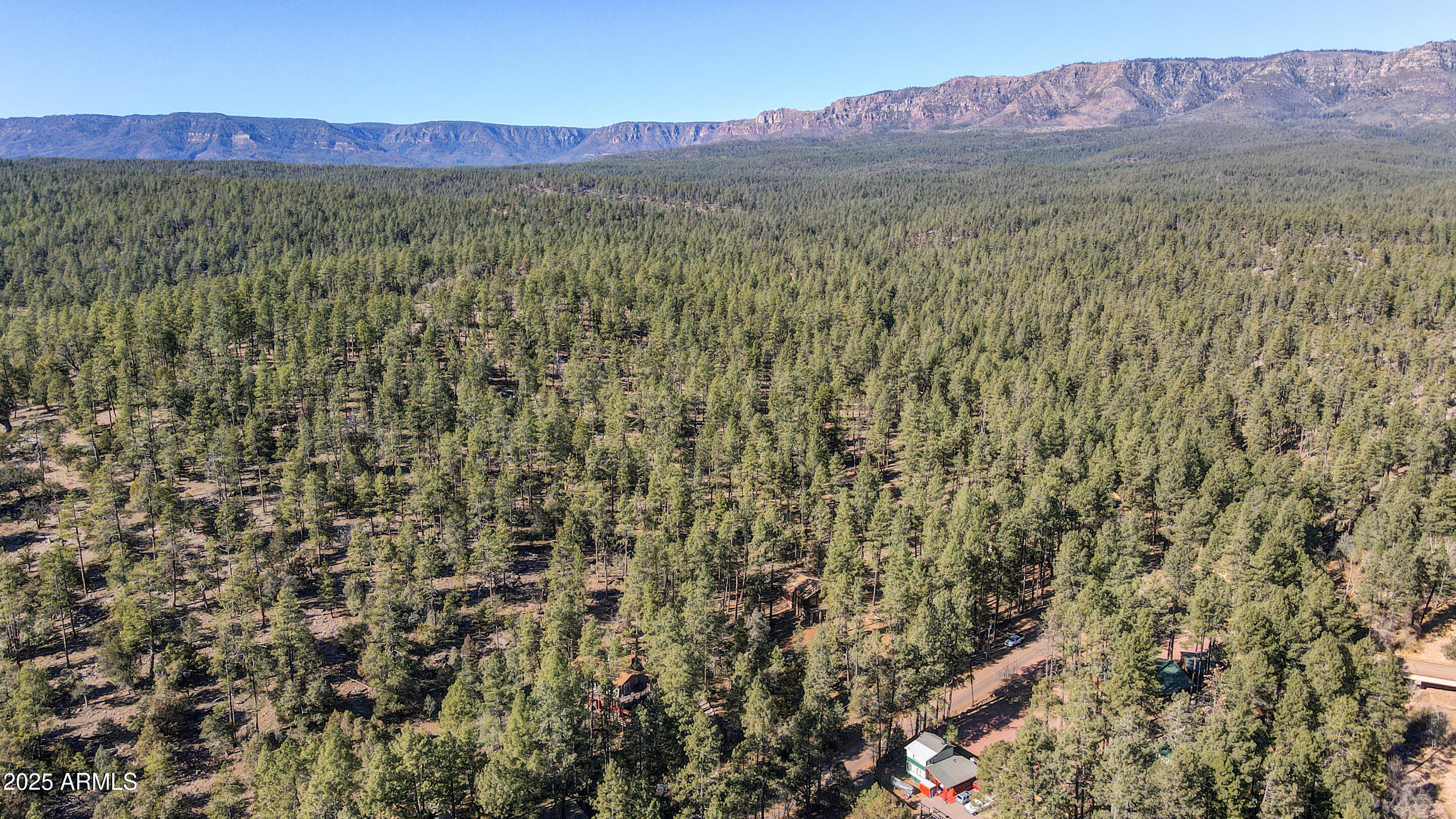 11180 Houston Mesa Road, Unit 77 Payson, AZ 85541 - Photo 6 of 11 a view of a lush green hillside and a building