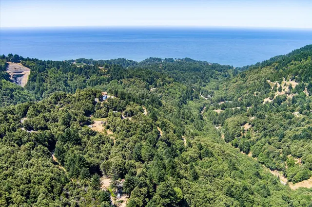 an aerial view of a city and mountain