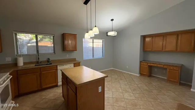 a kitchen with a sink cabinets and window