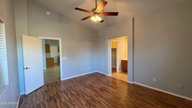 a bedroom with a bed and a chandelier fan