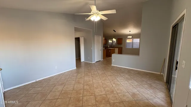 a view of a livingroom with a ceiling fan and window