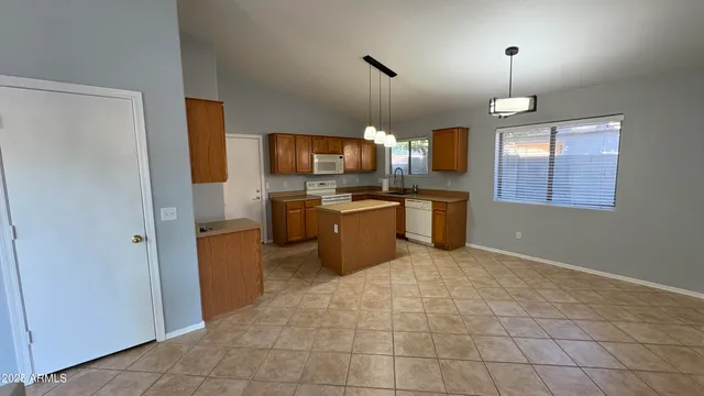 a open kitchen with a refrigerator a sink and a stove