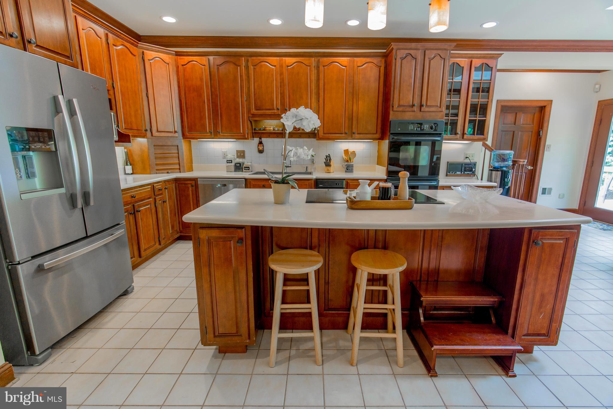 610 Bryants Nursery Road Silver Spring, MD 20905 - Photo 13 of 30 a kitchen with stainless steel appliances granite countertop a stove refrigerator and a microwave